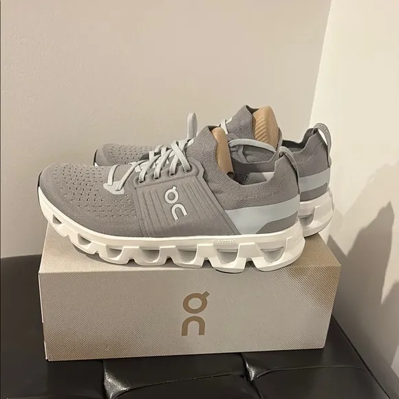 On Running Gray and White Athletic Shoes with Cloud Pods